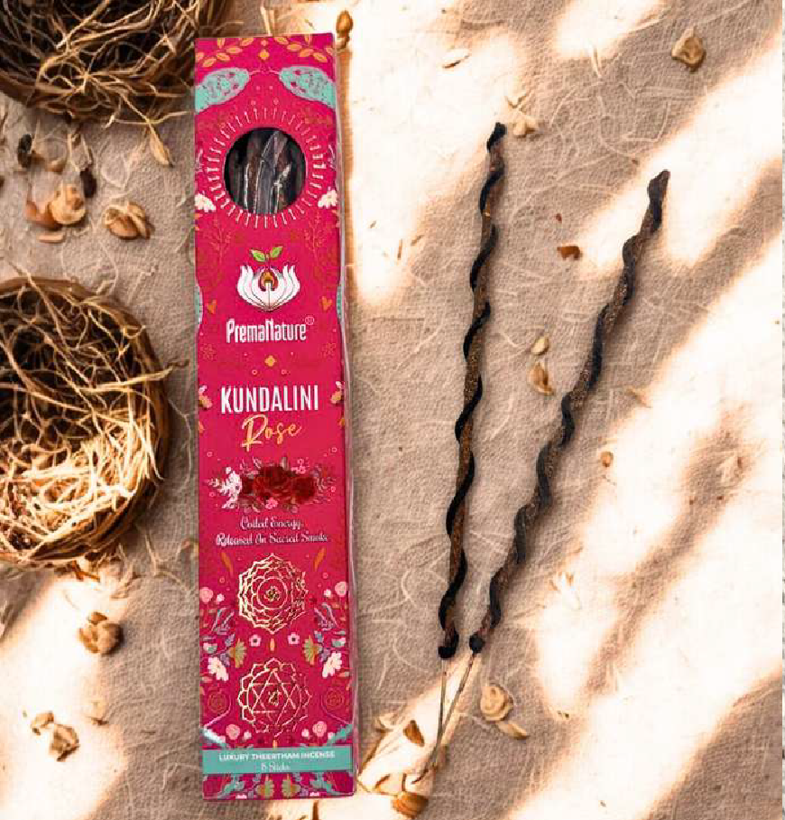 Kundalini Rose incense packaging on a textured surface with dried elements