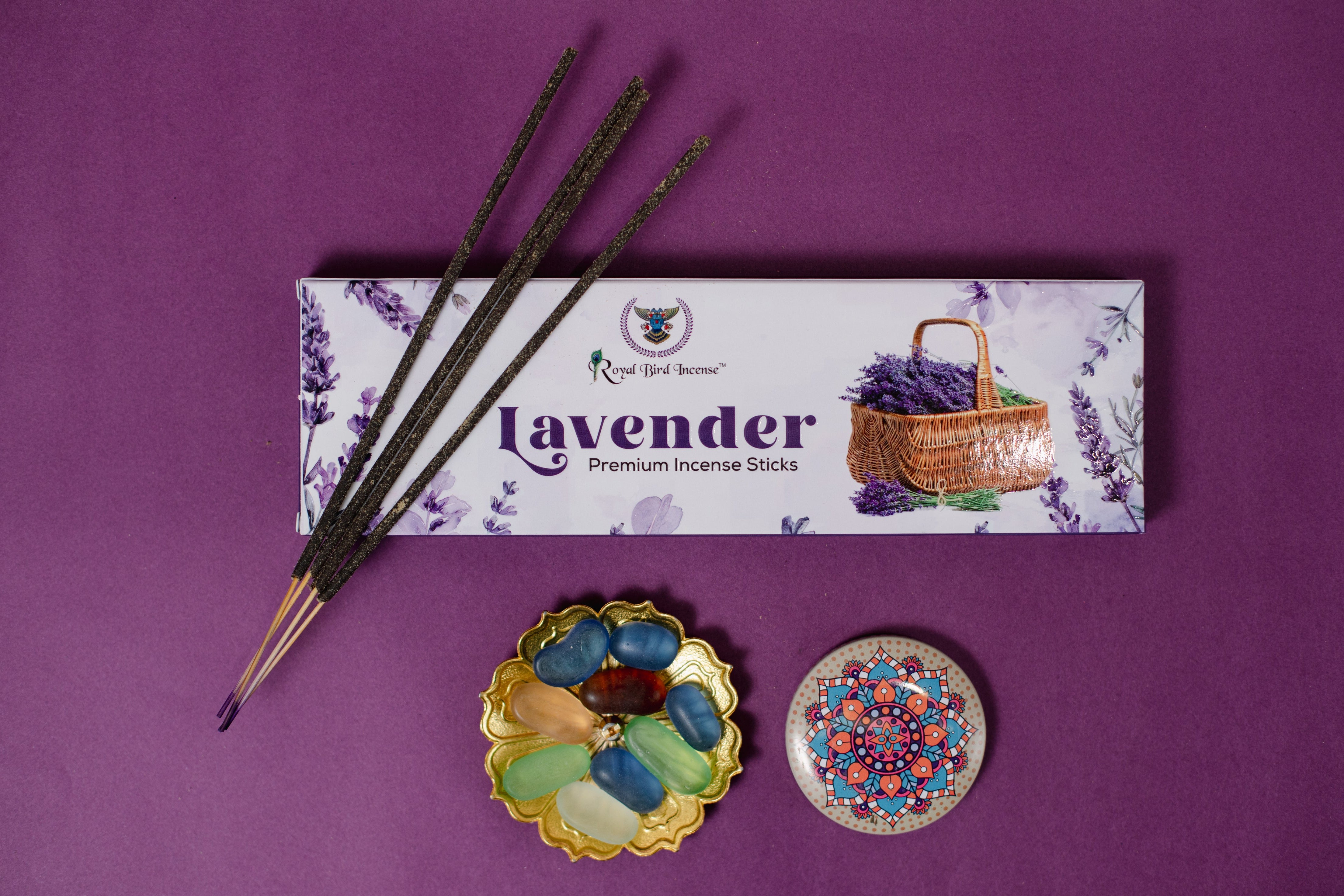 Lavender incense sticks with packaging on a purple background