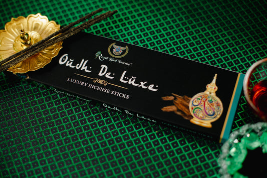 Box of Oudh De Luxe luxury incense sticks on a green textured background